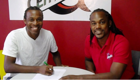 Central F.C. CEO, Brent Sancho, sees his latest addition, Yohance Marshall put pen to paper.