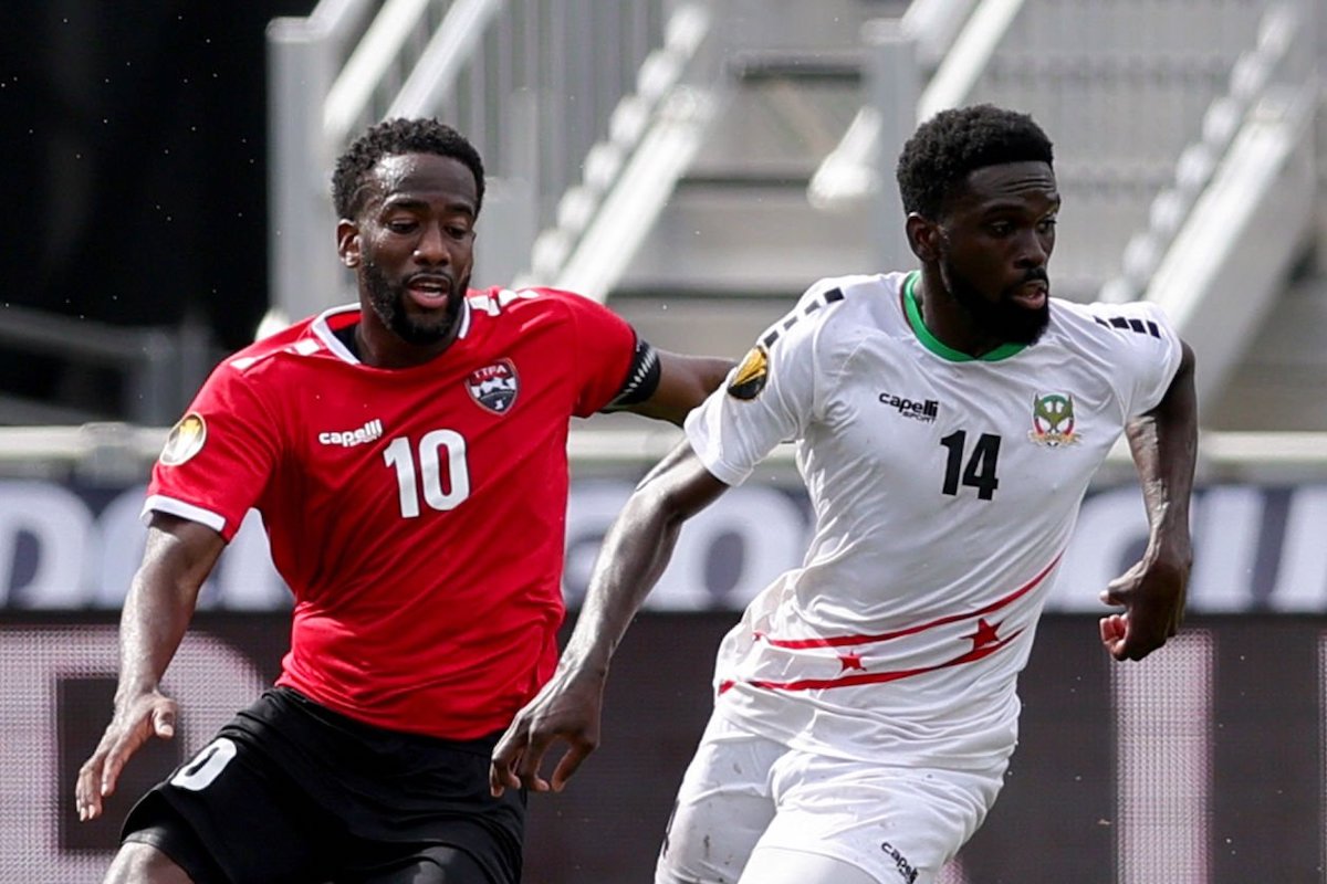 Kevin Molino #10 of Trinidad and Tobago and Raheem Somersall #14 of Saint Kitts and Nevis compete for the ball during the second half at DRV PNK Stadium on June 25, 2023 in Fort Lauderdale, Florida. (Photo by Megan Briggs/Getty Images)