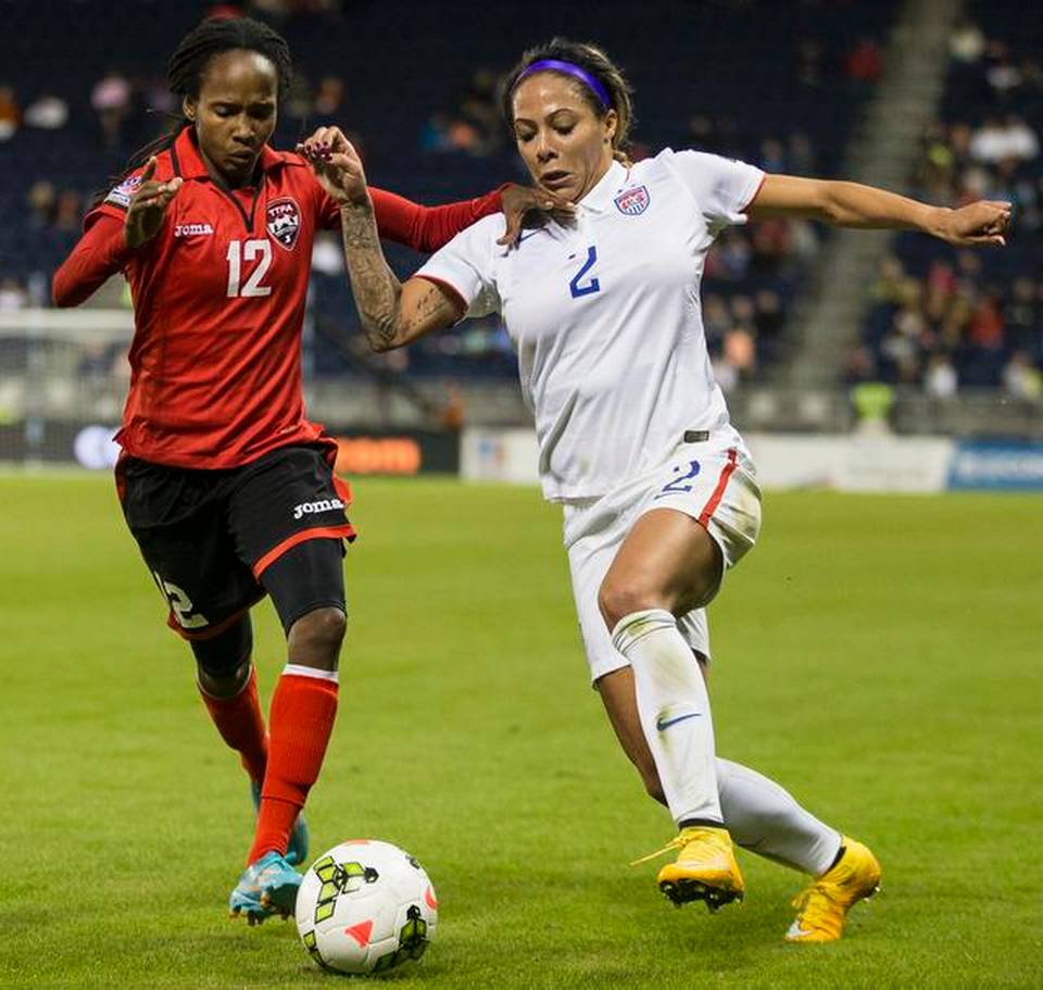 Sydney Leroux (2) of USA and Ahkeela Mollon (12) of Trinidad/Tobago compete for the ball during the CONCACAF Women's Championship at Sporting Park on Wednesday, October 15, 2014 in Kansas City, Kansas.