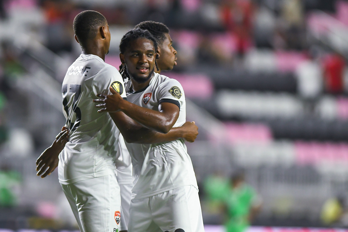 Trinidad and Tobago's Duane Muckette (center) celebrates with Reon Moore (left) and Dre Fortune during a 2021 Concacaf Gold Cup Preliminary Round match against Montserrat at DRV PNK Stadium, Ft. Lauderdale, FL on Friday, July 2nd 2021.