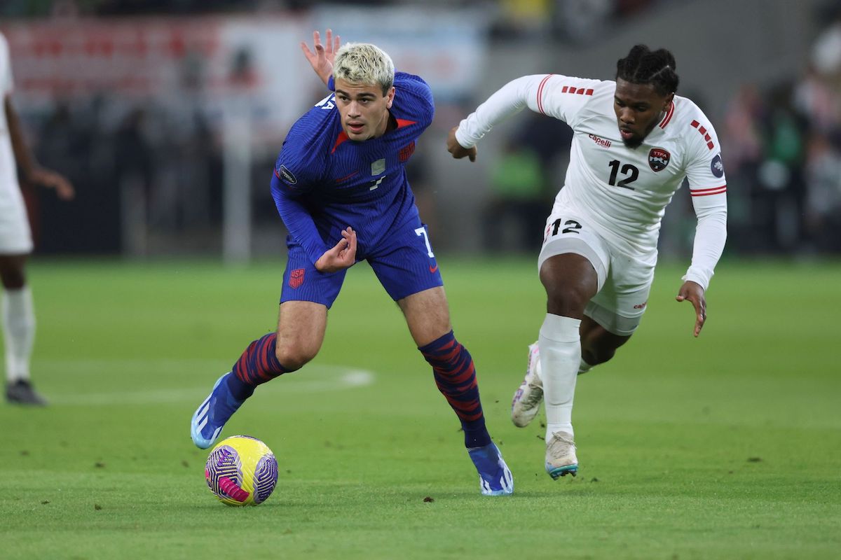 USA midfielder Gio Reyna, left, drives away from T&T midfielder Daniel Phillips, right, during the first half of the first leg of a CONCACAF Nations League soccer quarterfinal on Thursday, November 15th 2023 at Q2 Stadium in Austin, Texas, USA. PHOTO BY: Stephen Spillman