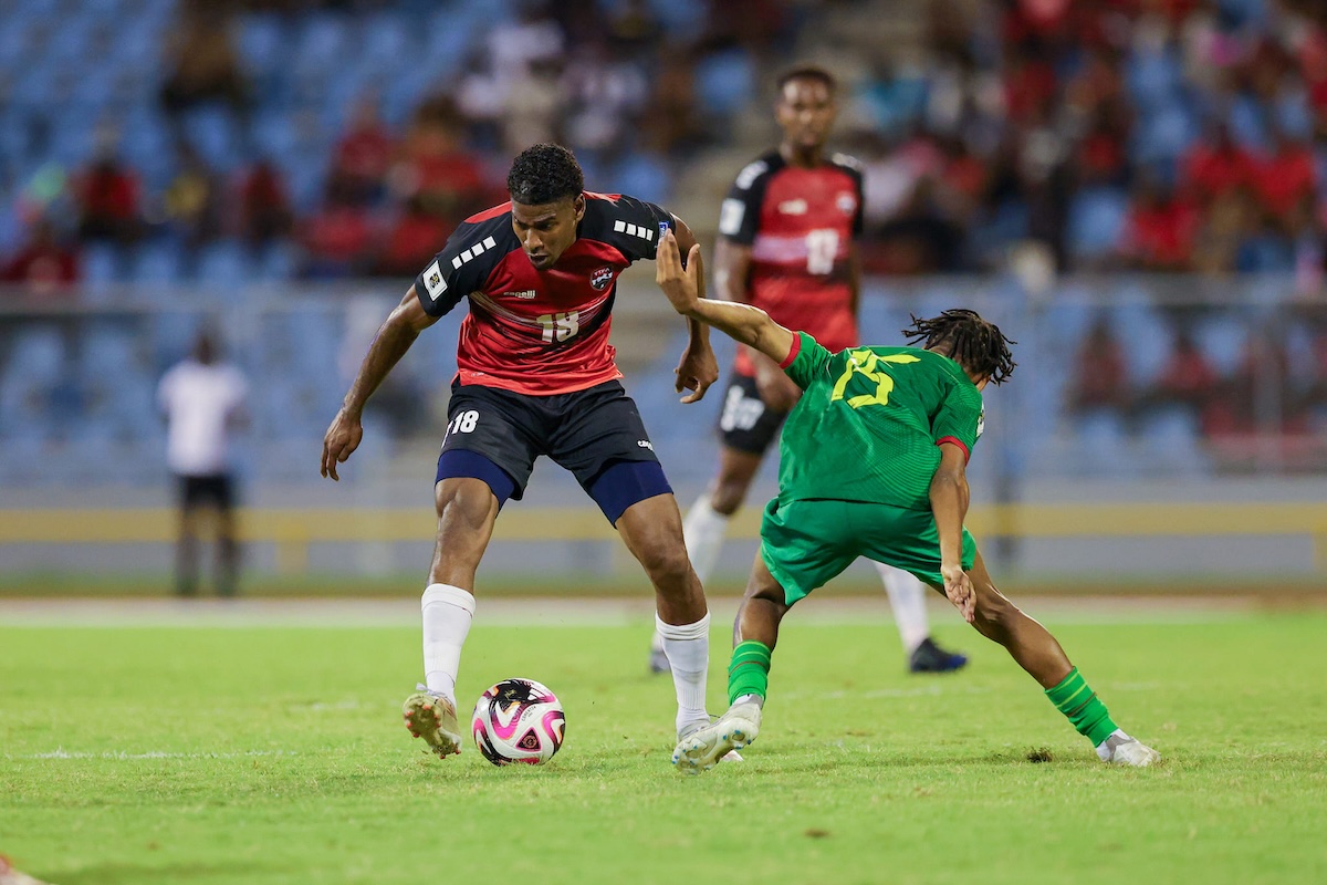 Trinidad and Tobago's Andre Rampersad (#18) goes past Grenada's Jermaine Francis (#15) during the second half of a 2026 Concacaf World Cup Qualifier at Hasely Crawford Stadium, Mucurapo on Wednesday, June 5th 2024.