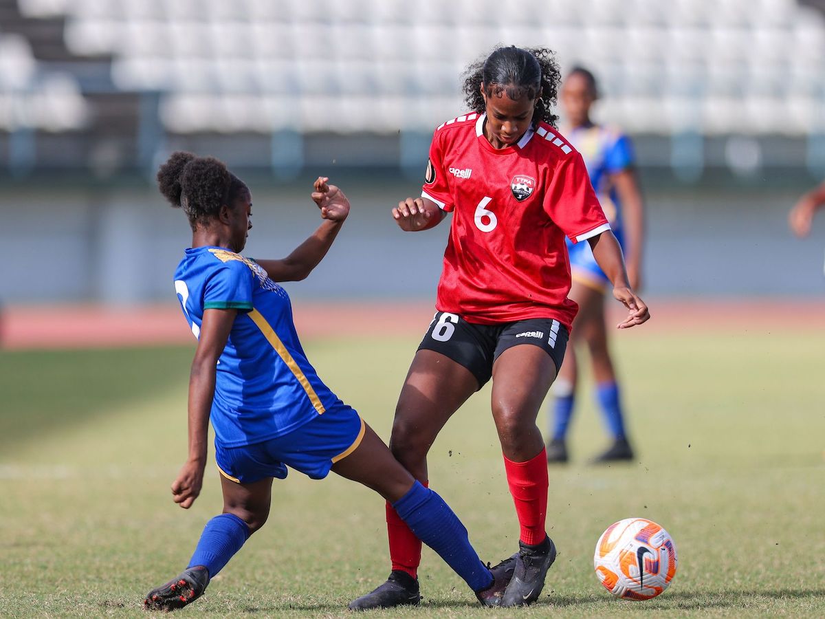 T&T girls U-17 A's Cherina Steele, right, sidesteps a strong challenge from SVG girls U-17s' Carmel Myers during the Jewels of the Caribbean U-17 Girls final match at the Larry Gomes Stadium in Malabar on Wednesday, December 20th 2023. T&T ‘A’ won 2-0. PHOTO BY: Daniel Prentice