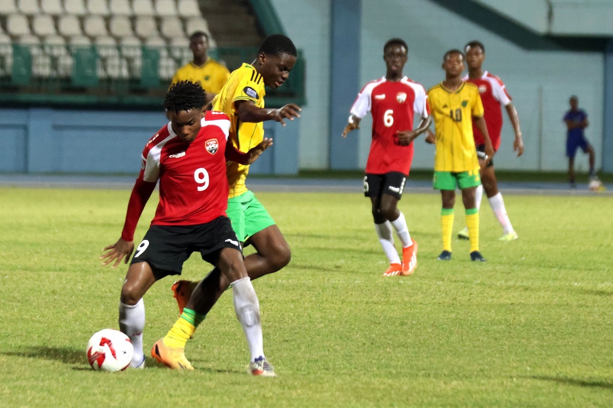 Trinidad and Tobago forward Jeremai Nanton (#9) fends of a challenge from a Jamaican player CFU U-14 Series action at the Dwight Yorke Stadium, Bacolet, Tobago on Monday, August 19th 2024.