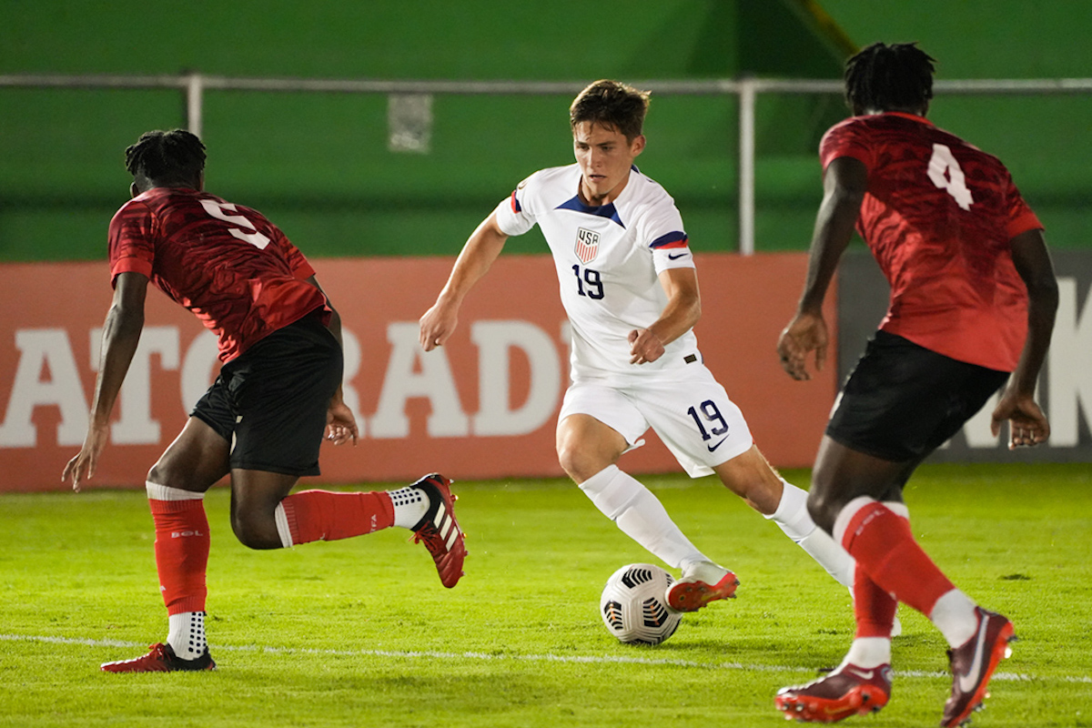 Trinidad and Tobago players Samuel Duncan (#5) and Lyshaun Morris (#4) challenge USA's Paulo Rudisill (#19) during a CONCACAF Men's Under-17 Championship match at Estadio Pensativo, Antigua, Guatemala on Monday, February 13th 2023.