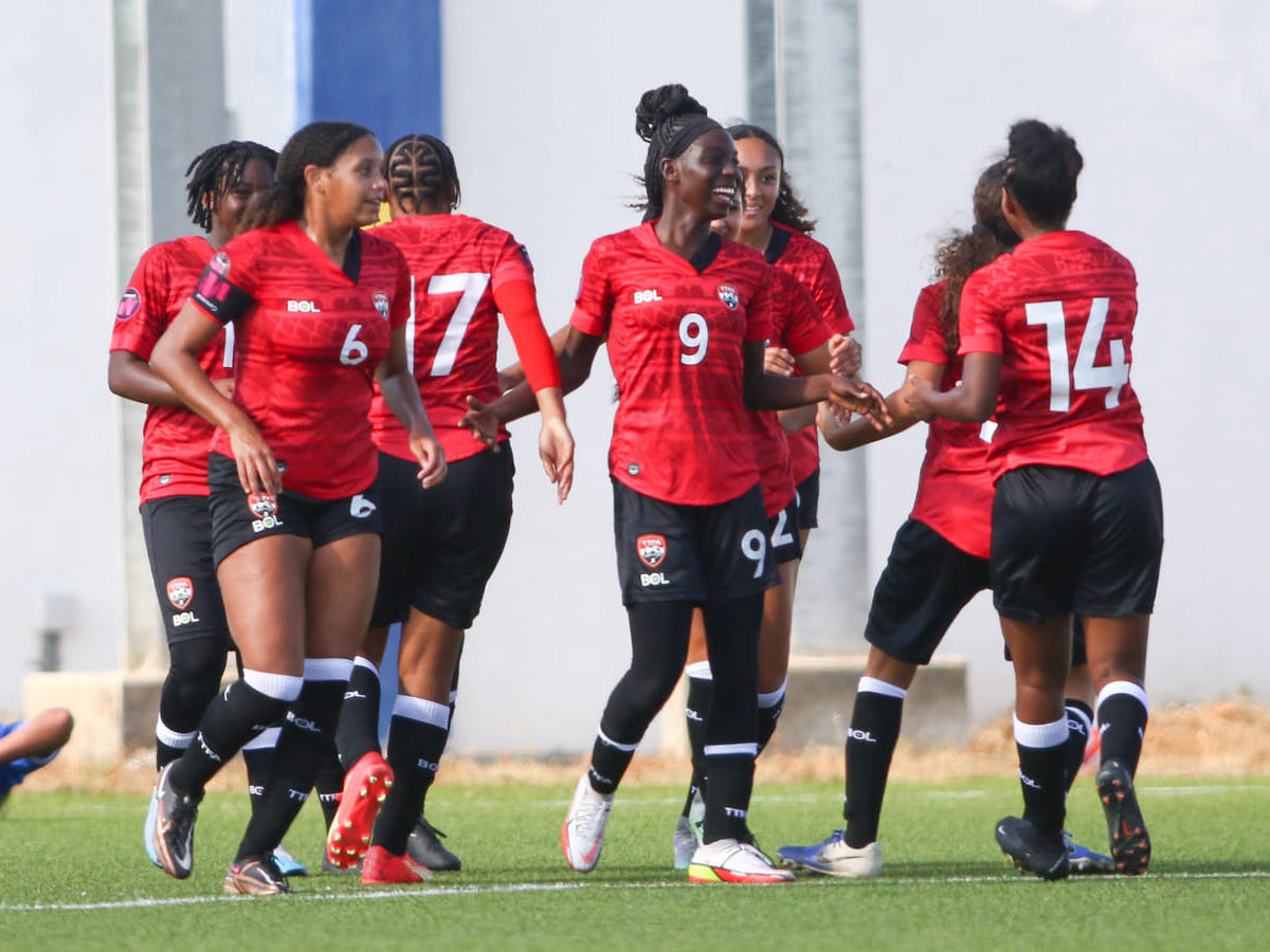 Trinidad and Tobago forward J’Eleisha Alexander (#9) is congratulated by teammates during their 3-0 win over the Cayman Islands on 15 April 2023 in Concacaf Championship qualifying action at the Rignaal Jean Francisca Stadium, in Willemstad, Curaçao. (Copyright Miguel Gutierrez/ Straffon Images)