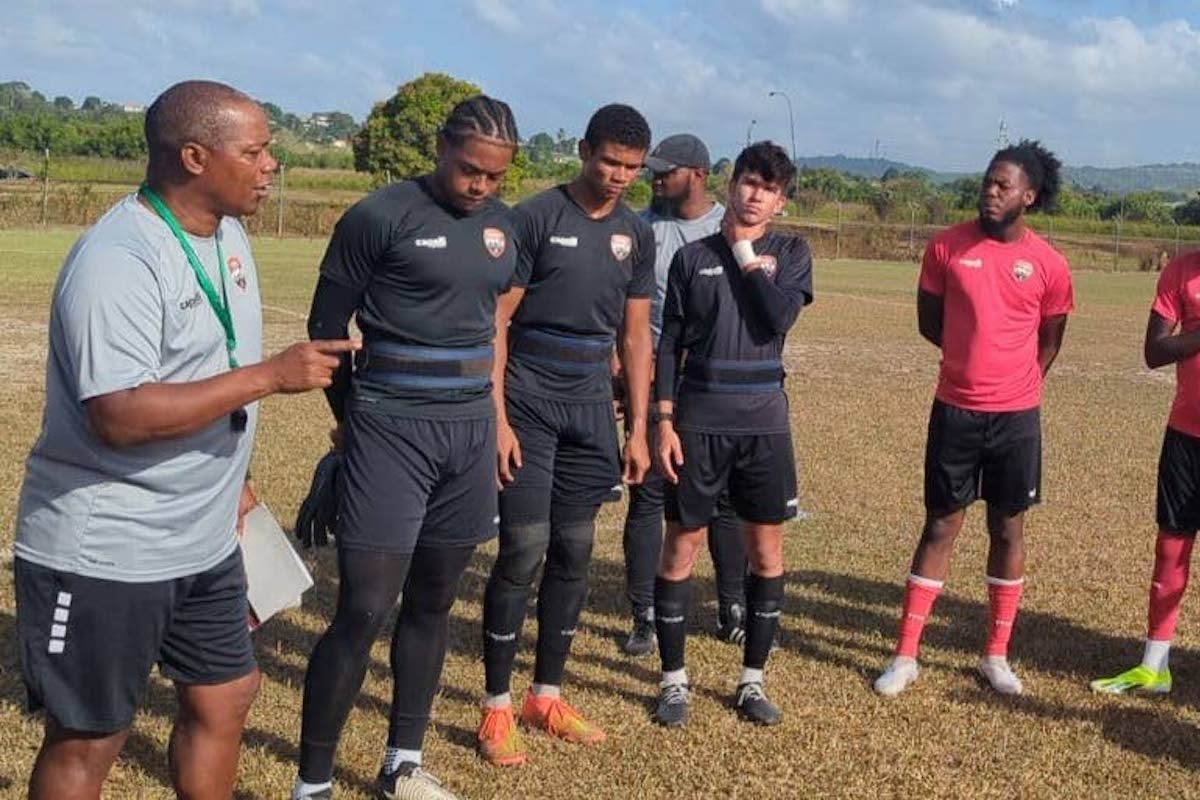 Trinidad and Tobago Men's U-20 Head Coach Brian Haynes, left, speaks to his young charges during a training session on Thursday, February 15th 2024.