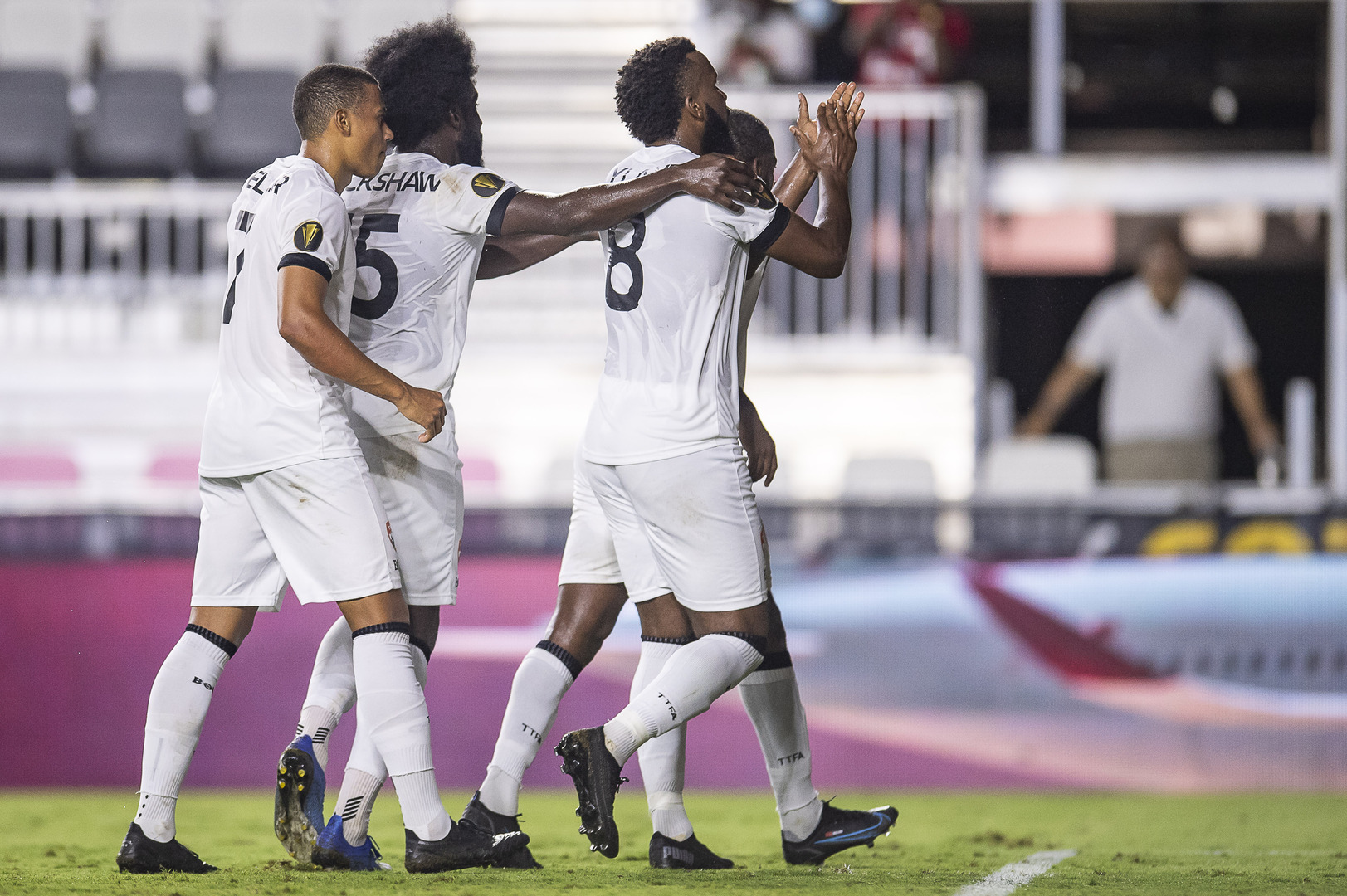 (L-R): Ryan Telfer, Neveal Hackshaw, Khaleem Hyland, and Kevin Molino celebrates Molino's successful penalty kick during a 2021 Concacaf Gold Cup Preliminary Round match against Montserrat at the DRV PNK Stadium, Ft. Lauderdale, FL on Friday, July 2nd 2021.