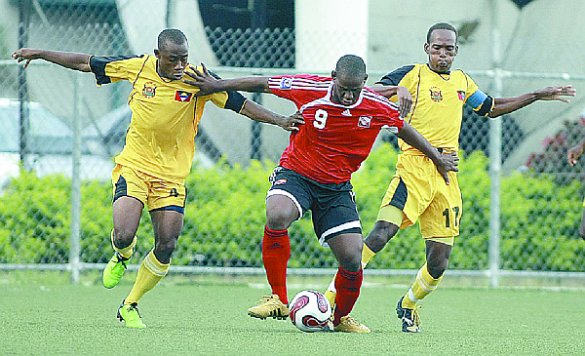 Soca Warriors striker, Devon Jorsling, centre, fends off the challenge from two Antigua & Barbuda players during their international friendly at the Marvin Lee Stadium, Macoya, July 11. T&T won 4-1. Photo: Anthony Harris
