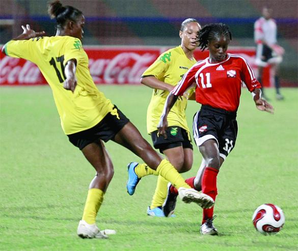 Jamaica's Shanese Bowen, left, challenges T&T's Khadidra Debesette, right, for the ball during an encounter between the teams in the U-17 Four Nation Tournament on Sunday night at the Mannie Ramjohn Stadium, Marabella. The match finished 0-0. Photo: ANTHONY HARRIS