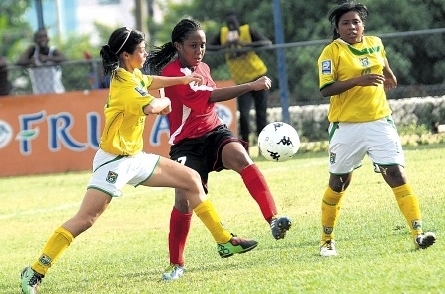 Guyana’s Kailey Leila (left) challenges Trinidad’s Jonnelle Warrick (centre) for a ball during their CFU Under-17 final-round World Cup qualifier at the Tony Spaulding Complex yesterday. Leila’s teammate Ursuline Primus (right) looks on. T&T won the game, 8-0. (Photo: Jermaine Barnaby)