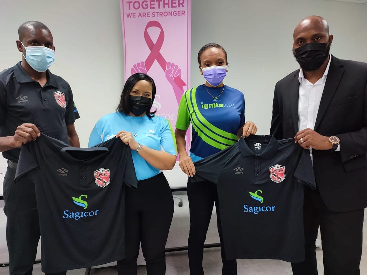 Mrs Rachael Kangalee (second from left), Senior Life Advisor and Mrs Talia Simpson-Grant (second from right), Client Relations Officer, Group Business receive UFCTT jerseys from Jefferson George (right) Interim President and Rayshawn Mars (left) General Secretary both of UFCTT.