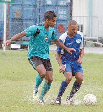 WASA FC midfielder Fabian Garcia, right, in a battle of number 7s with Westside Superstarz’s Qian Grosvenor, in the blink/bmobile National Super League clash, on Sunday. The match was eventually abandoned due a waterlogged pitch, at WASA Ground, St Joseph. Photo: Anthony Harris.