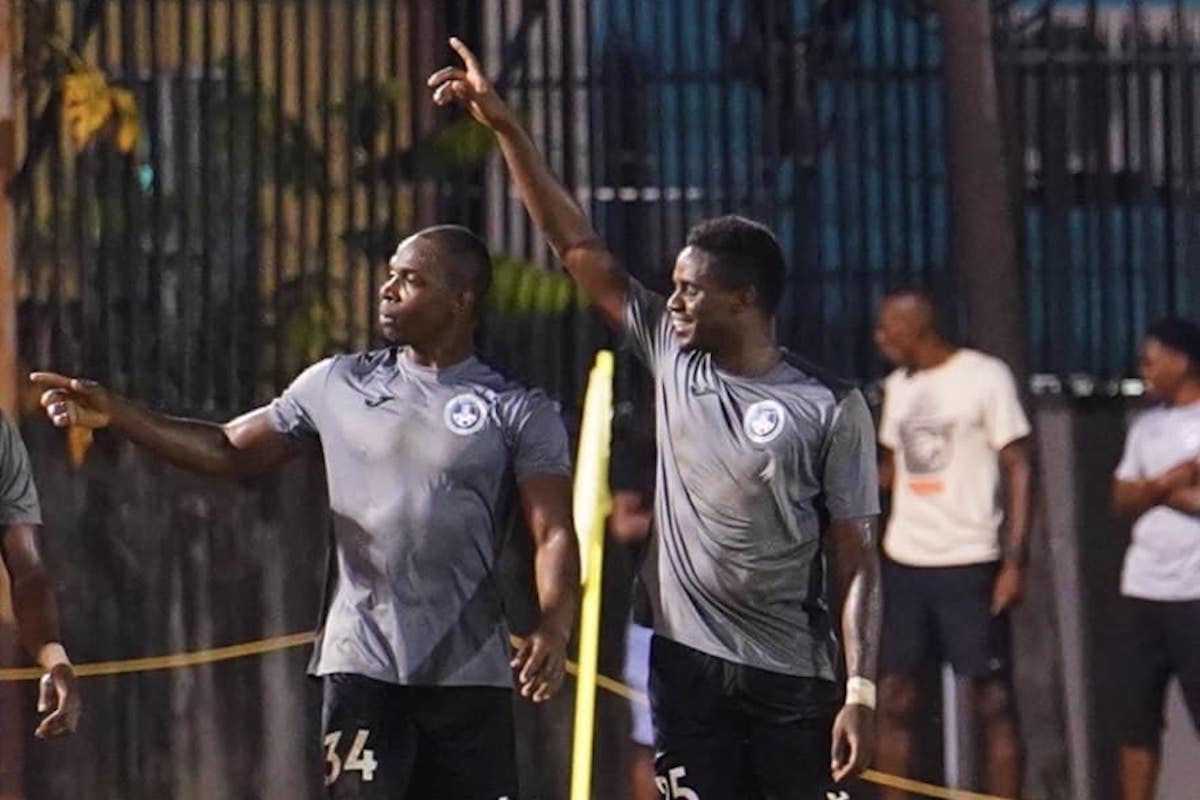Police FC's Anthony Wolfe (left) and Joevin Jones (right) celebrate a goal during their 1-1 draw with AC Port of Spain on June 11th 2023.