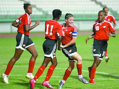 Soca Princesses’ captain, Anique Walker, centre celebrates with team-mates as another goal is scored against Dominica in their CFU Under-17 Group B qualifier at the Larry Gomes Stadium, Malabar on Wednesday.Photo: Anthony Harris