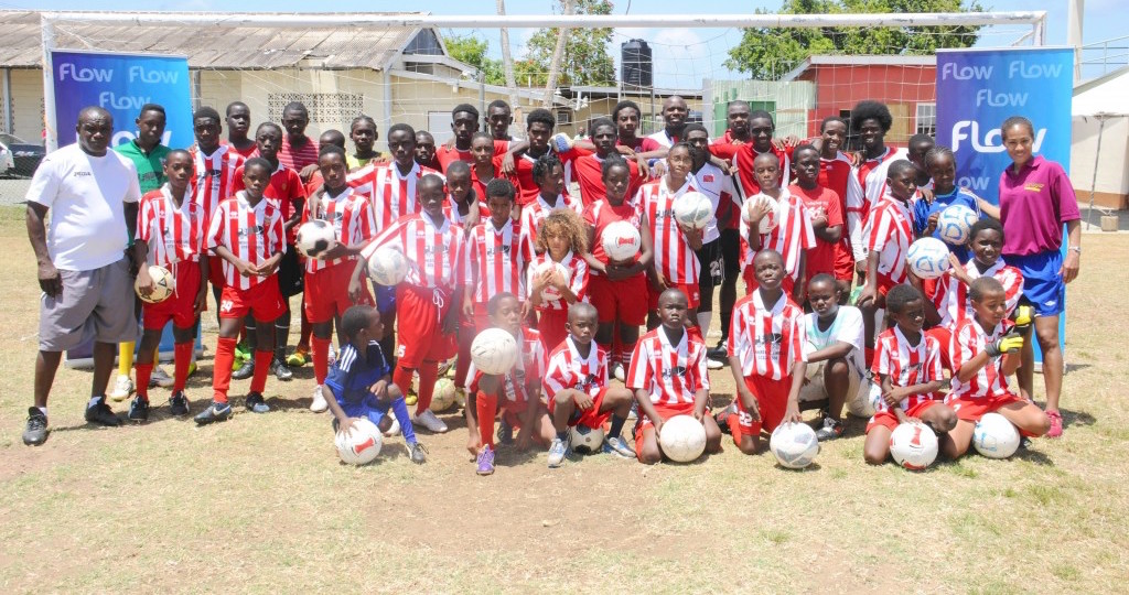 Rachel Yankey (extreme right) and Fabrice Muamba (middle back) share a team moment with members of the 1975 Phoenix Coaching School following the coaching session at the Canaan/Bon Accord Grounds on Sunday 17th May as part of the Flow Legends Community Legacy Outreach Programme