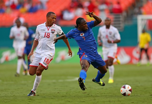 theobald-vs-haitiMIAMI GARDENS, FL - JULY 12: Jeff Louis #7 of Haiti fights for the ball with Densil Theobald #18 of Trinidad & Tobago during a CONCACAF Gold Cup game at Sun Life Stadium on July 12, 2013 in Miami Gardens, Florida. (Photo by Mike Ehrmann/Getty Images)