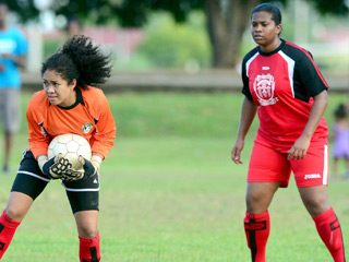 TRINCITY RANGERS: Trincity Nationals keeper Linfah Jones, left, clutches the ball while Jonelle Warrick looks on in background. Trincity beat Rangers 5-0 in a Women’s League Football match recently on the Eddie Hart Ground. —Photo: Robert Taylor