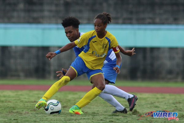 Photo: Shiva Boys Hindu College maestro Tyrel “Pappy” Emmanuel (right) tries to shake off Presentation College (San Fernando) midfielder Terrell Williams during the South Zone Intercol final at the Mannie Ramjohn Stadium on 18 November 2016. (Courtesy Chevaughn Christopher/Wired868)