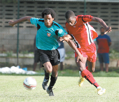 Westside Superstarz’s Akim Ash and Stephano Wright of Tobago’s 1976 FC Phoenix tussle for possession during a Blink/bmobile National Super League Match Day One clash, at St Anthony’s College Ground, Westmoorings, on Wednesday. Ash was on target as Westside eased to a 3-0 win. Photo: Anthony Harris